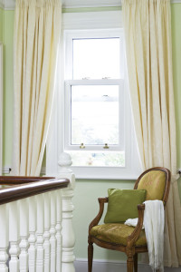 Timber sliding sash window by Anglian Home Improvements myglazing ggf chair