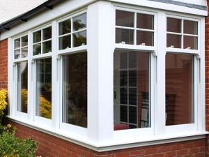 white upvc sash windows in corner of brick home