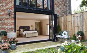 Bedroom with aluminium bi-folding doors Anglian Home Improvements myglazing ggf