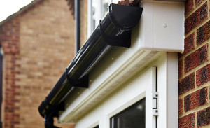 White uPVC facsias and soffits with black gutters and downpipes by Anglian Home Improvements myglazing ggf