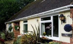 Bungalow with white uPVC gutters by Anglian Home Improvements myglazing ggf