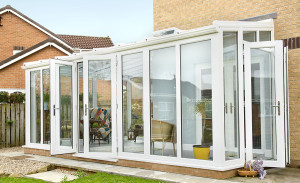 White PVCu lean to conservatory with French doors by Anglian Home Improvements myglazing ggf