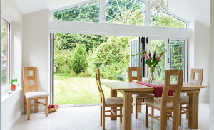 White PVCu extension with gable end and bi-folding doors by Anglian Home Improvements myglazing ggf