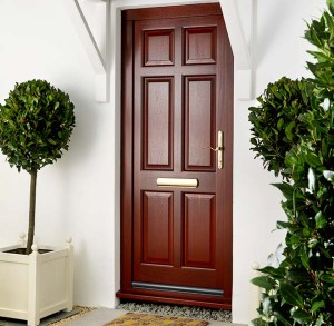 dark woodgrain entrance door with potted trees