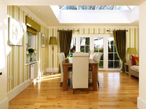 orangery interior with wooden floors, striped wallpaper and dining suite