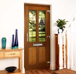 Wooden entrance door with leaded glass pane and house entrance area