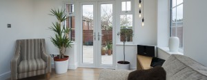 living room with plants, furniture and french doors