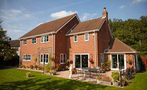 Large two storey brick home with garden and patio