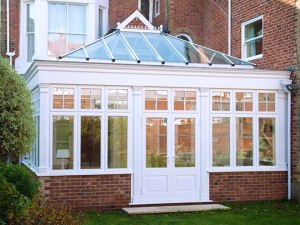 white timber conservatory extension on brick home