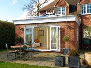 brick conservatory with open french doors and outdoor table and chairs
