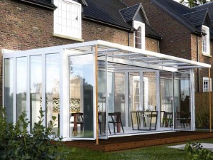 Modern fully glazed conservatory with wood decking
