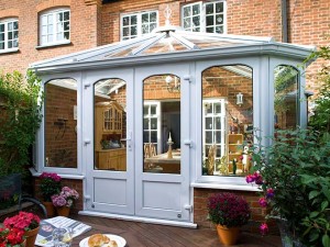 Brick home with white conservatory extension