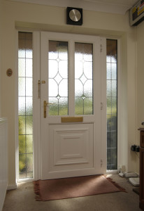 White uPVC front door with leading by Anglian Home Improvements myglazing ggf