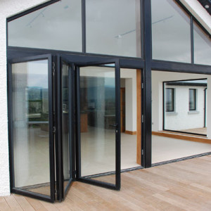bifold doors with black framing opening onto wooden deck