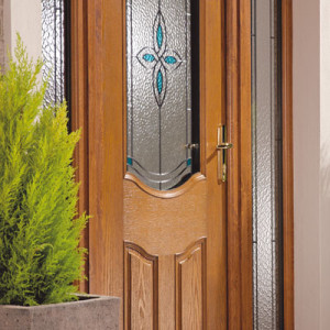 timber front door with stained glass and potted plant