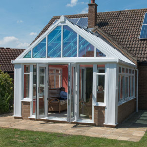 white gabled conservatory with open french doors