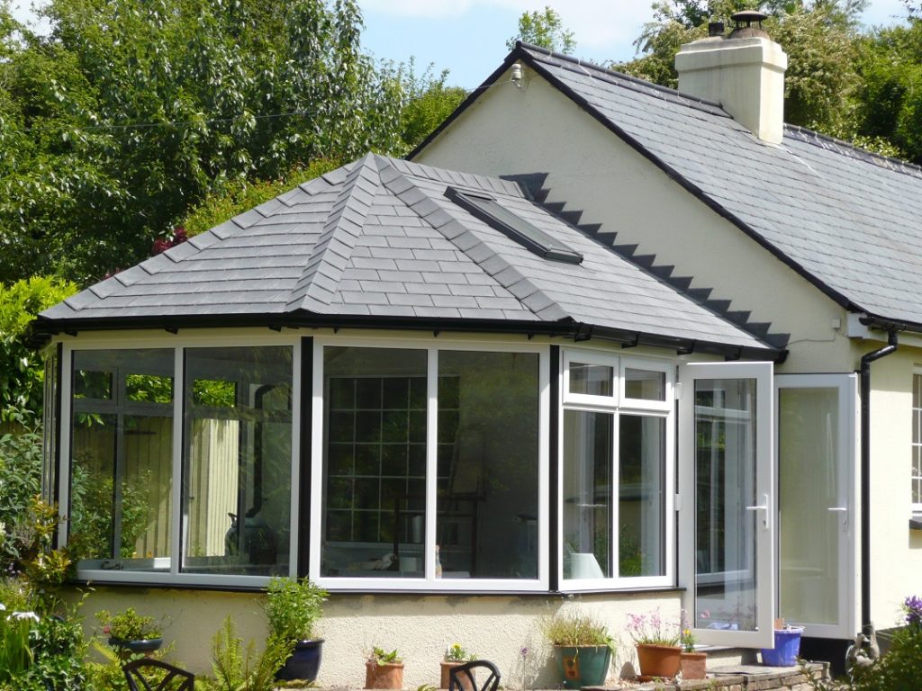 Conservatory with tiled roof on end of gabled house