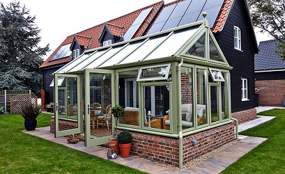 Edwardian gable conservatory with green framework by Anglian Home Improvements