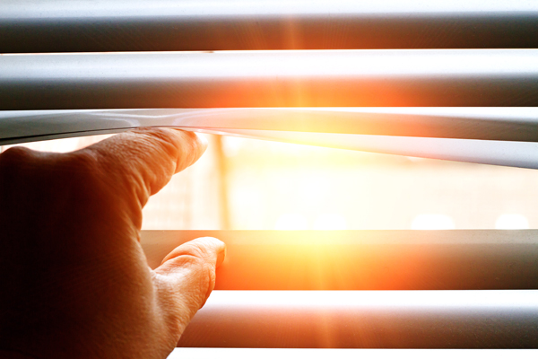 window blinds open view of sunset
